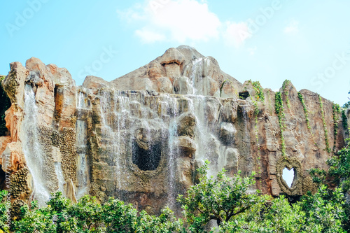 manmade waterfall park. flowing water stream photo