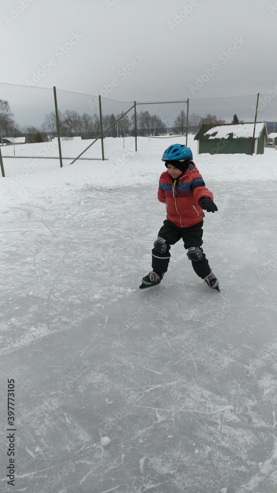A little boy ice-skating in winter with various poses.