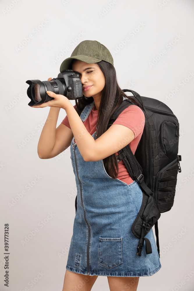 Female photographer taking picture with digital camera on white. Female photographer taking picture with digital camera on white.