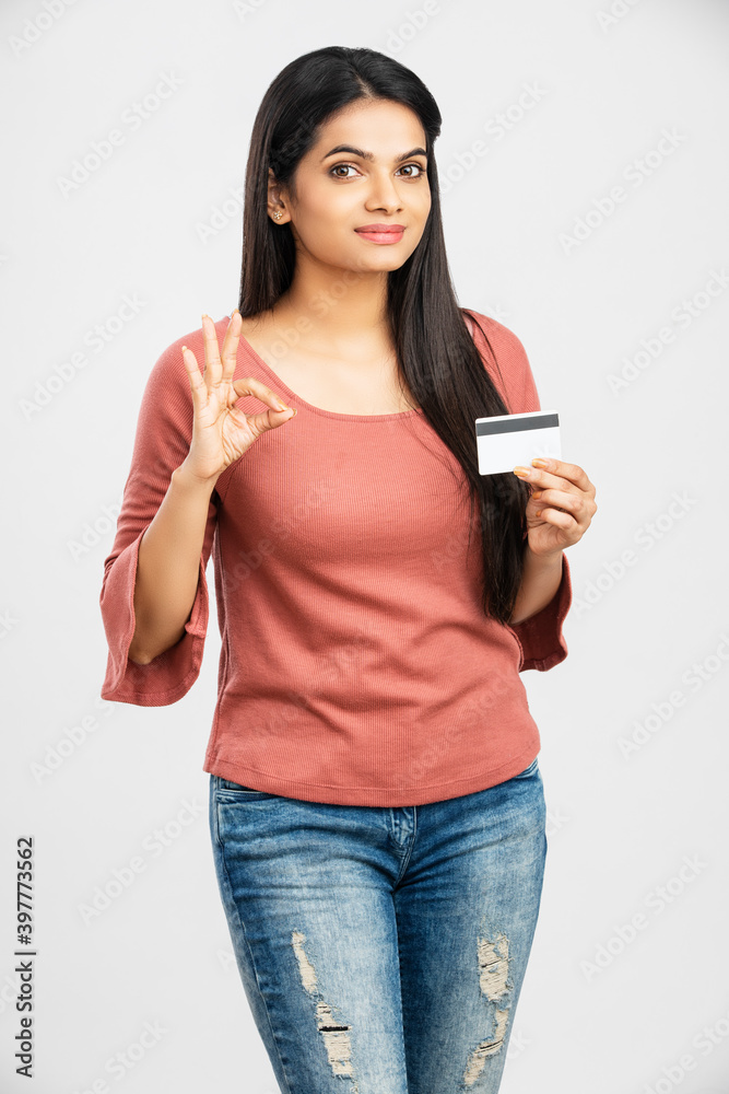 Beautiful young woman holding credit card on white. Beautiful young woman holding credit card on white.