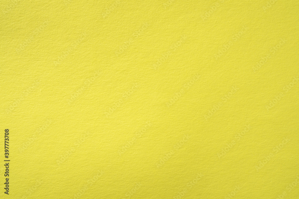 Obraz premium Paper background of pastel yellow color with fine texture.