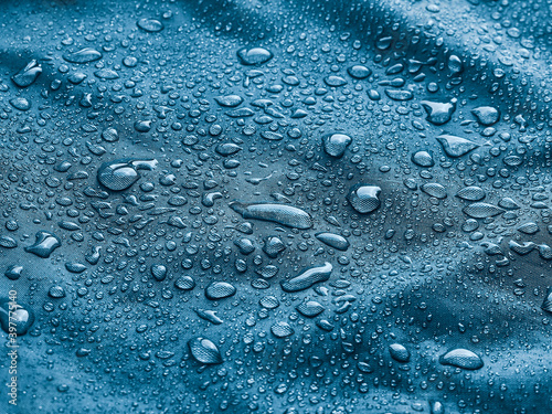 Rain water droplets on waterproof fabric.