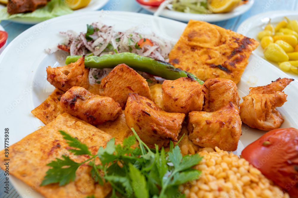 chicken shish kebab in a plate with appetizers chicken shish kebab in a plate with appetizers