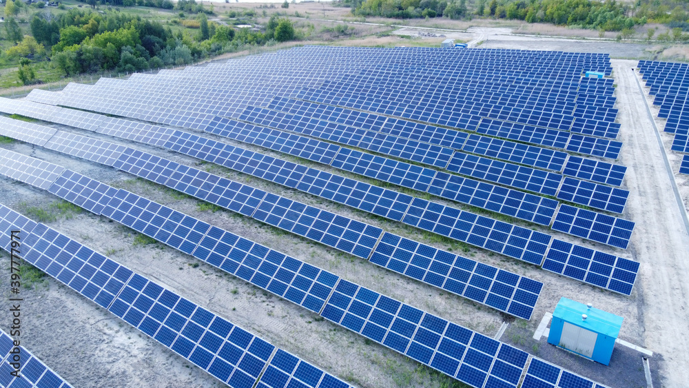 Background of solar panels array as seen from above the modern static solar power station. Green energy background. Background of solar panels array as seen from above the modern static solar power station. Green energy background.