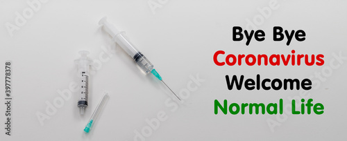 bye bye coronavirus welcome life inscription in the middle of syringes on a white background