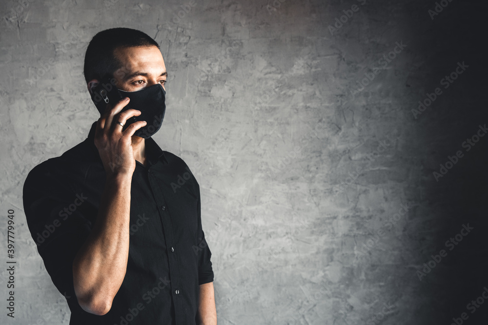 Caucasian man in mask. Protection versus viruses and infection. He is calling on the phone Caucasian man in mask. Protection versus viruses and infection. He is calling on the phone