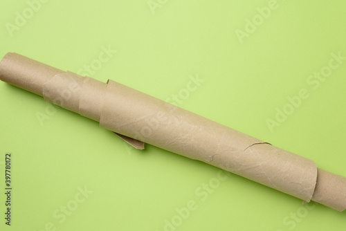 roll of brown parchment paper on a green background photo