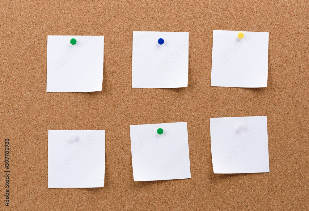 white square blank pieces of paper pinned on a cork board white square blank pieces of paper pinned on a cork board