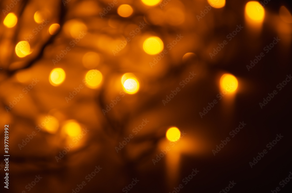 Abstract golden bokeh lights glowing on dark background
