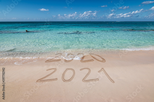 New year 2021 written on the beach.