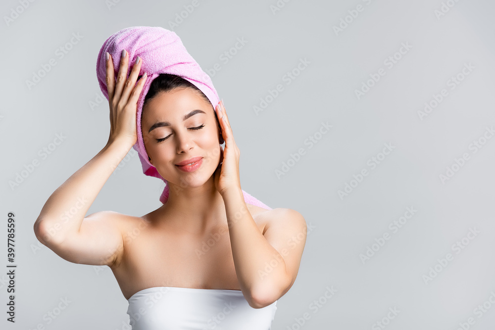 pleased beautiful woman with towel on hair isolated on grey pleased beautiful woman with towel on hair isolated on grey