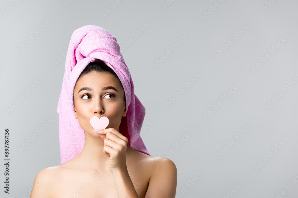 beautiful woman with towel on hair holding heart shaped sponge isolated on grey beautiful woman with towel on hair holding heart shaped sponge isolated on grey