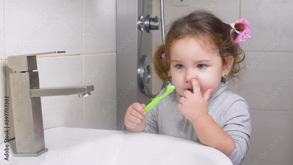 The girl in the bathroom picking your nose and thinking about something funny The girl in the bathroom picking your nose and thinking about something funny