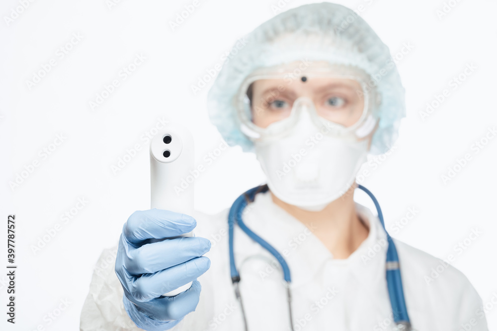 Doctor in protective suit pointing infrared thermometer to check body temperature epidemic virus outbreak concept Doctor in protective suit pointing infrared thermometer to check body temperature epidemic virus outbreak concept