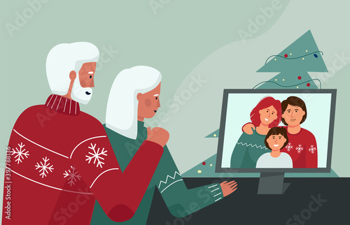 An elderly couple communicates with relatives through a video conference. Christmas and new year online. Quarantine conditions of the celebration.