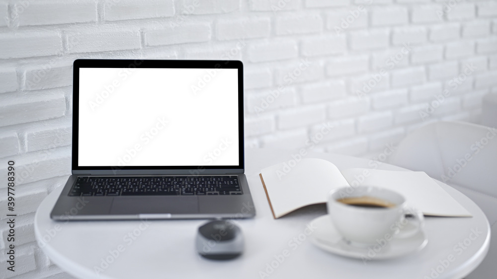 Mockup laptop screen blank empty with notebook on white modern table in cafe, White brick background. Mockup laptop screen blank empty with notebook on white modern table in cafe, White brick background.