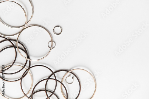 rings and bracelet on white background. background with a glass. jewelry