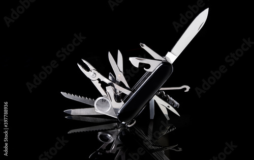 multipurpose pocket knife on black background