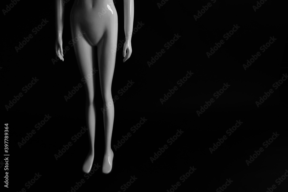 Fototapeta premium White mannequin on a dark background, background for text
