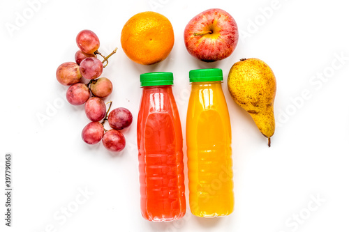 colorful plastic bottle with fruit on white background top view mock up