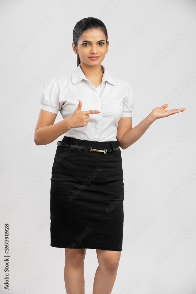 Pretty Indian business woman greeting on white. Pretty Indian business woman greeting on white.