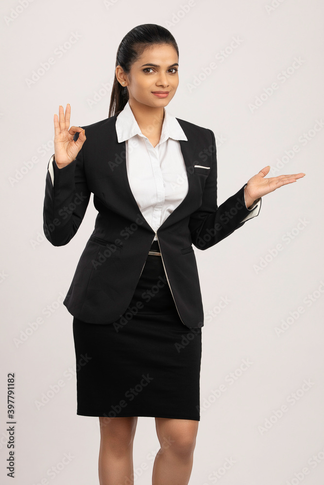 Pretty Indian business woman greeting on white. Pretty Indian business woman greeting on white.