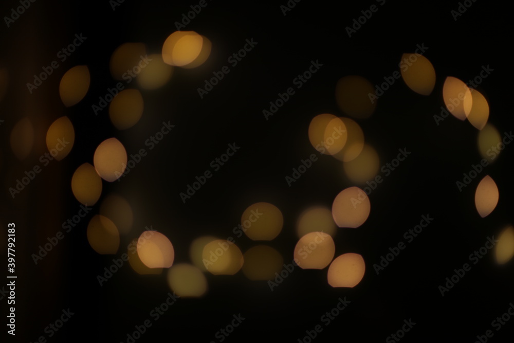 Background of golden, yellow bokeh (led strip light in a 50mm lens) on a dark black background. Design elements Background of golden, yellow bokeh (led strip light in a 50mm lens) on a dark black background. Design elements