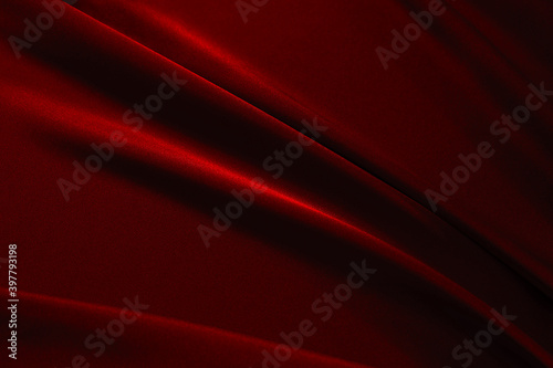 Red black elegant abstract background. Silk satin fabric with nice folds. Luxurious dark red background with wavy lines. Valentine, anniversary, wedding, birthday, holiday concept.