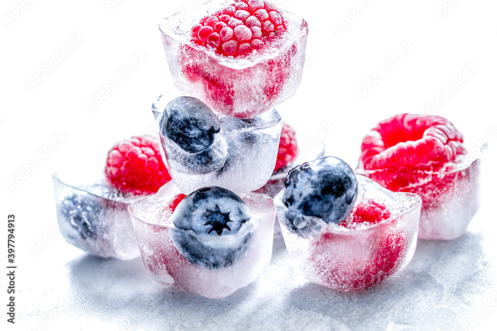 fresh blueberry and raspberry in ice on table background fresh blueberry and raspberry in ice on table background