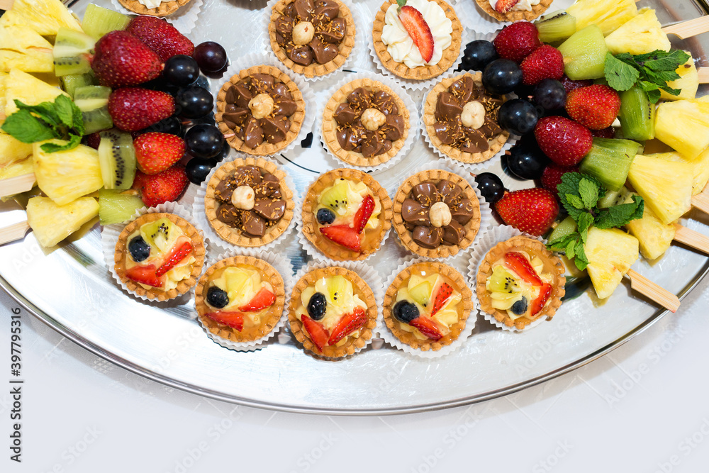 The buffet at the reception. Assortment of canapes on a table. Banquet service. Catering food, snacks with different types of cheese, ham, salami, prosciutto, shrimp, vegetables and fruits. Party Conc The buffet at the reception. Assortment of canapes on a table. Banquet service. Catering food, snacks with different types of cheese, ham, salami, prosciutto, shrimp, vegetables and fruits. Party Conc