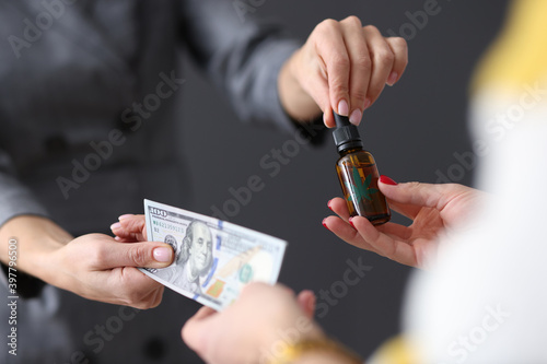 Photography Womens hands transferring money and collecting marijuana extract closeup