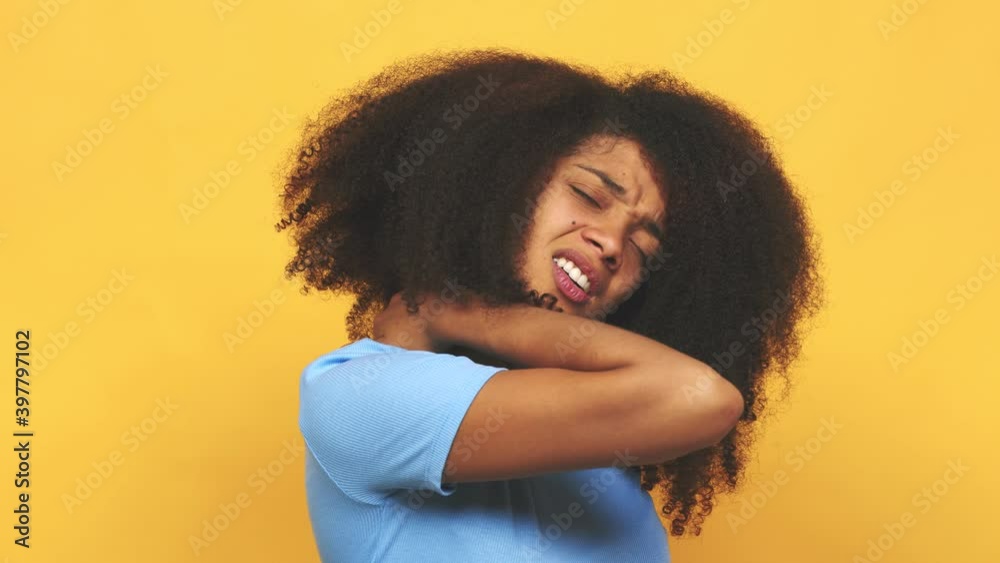 Young african american curly woman suffering neck pain due to sedentary lifestyle Young african american curly woman suffering neck pain due to sedentary lifestyle