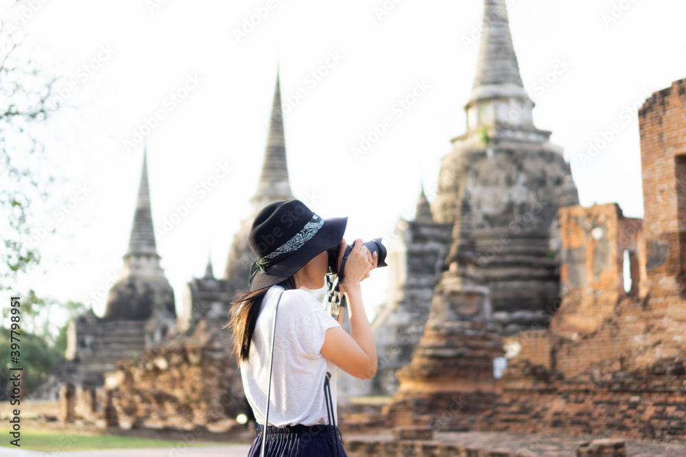Asian female tourists taking pictures at Wat Phra Si Sanphet, Phra Nakhon Si Ayutthaya, Thailand.