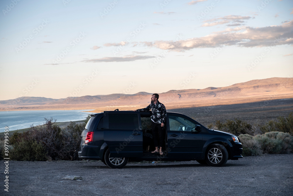 Fototapeta premium young man living in his van in the mountains