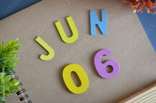 June 6, Cover design in natural concept with a brown notebook and colorful wooden alphabet. photo