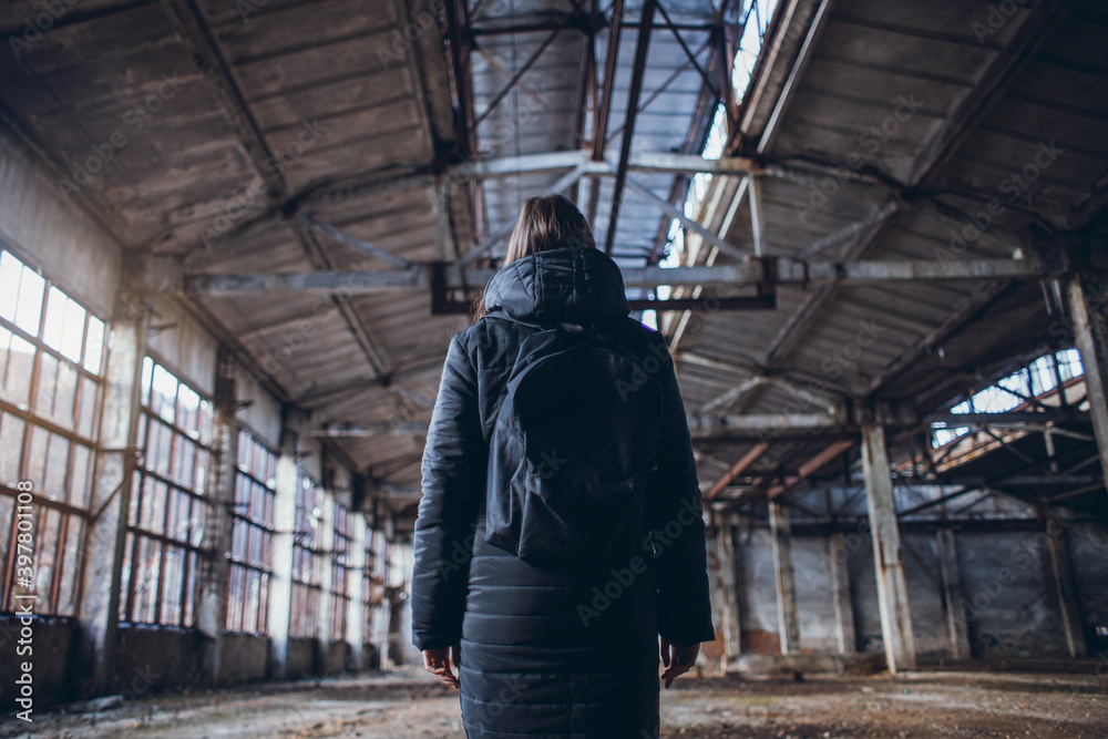 lonely girl in a black jacket in the Big Abandoned Hall lonely girl in a black jacket in the Big Abandoned Hall