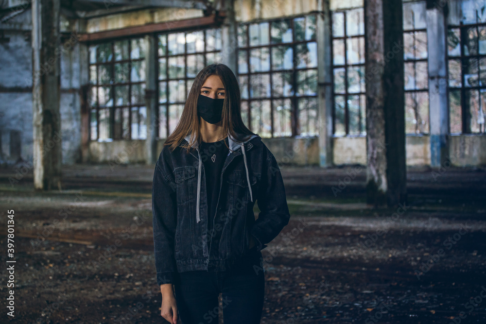 Fototapeta premium Young Girl with Mask in Empty Broken Factory Hall