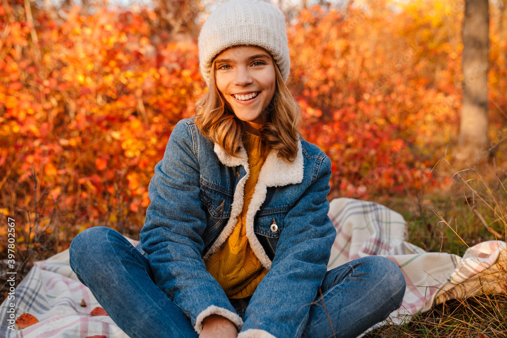 Girl sitting outdoors in autumn park Girl sitting outdoors in autumn park