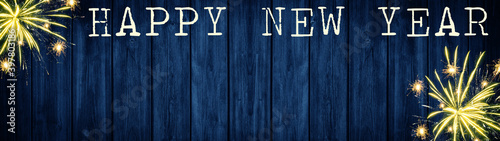 Happy New Year - Silvester background banner panorama long- sparklers, firework and bokeh lights on rustic sark blue wooden texture, with space for text	