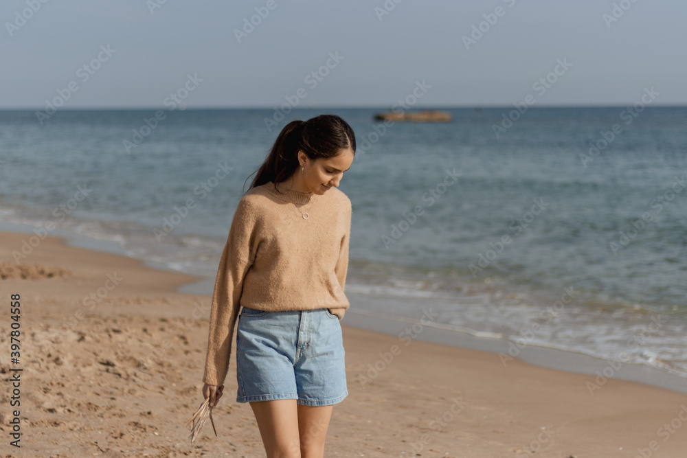 picture of pretty girl on the beach, portrayed playing with the waves of the sea picture of pretty girl on the beach, portrayed playing with the waves of the sea
