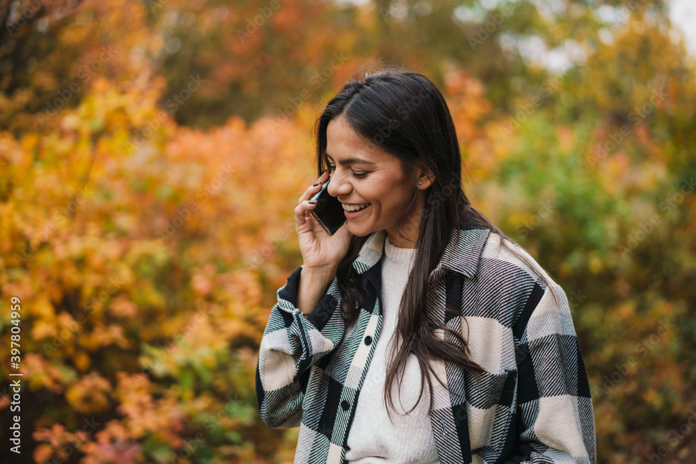 Smiling attractive woman using mobile phone Smiling attractive woman using mobile phone