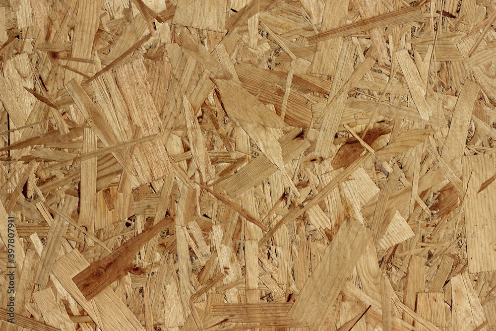Pressed texture of OSB plywood. Seamless background. Soft selective focus Pressed texture of OSB plywood. Seamless background. Soft selective focus