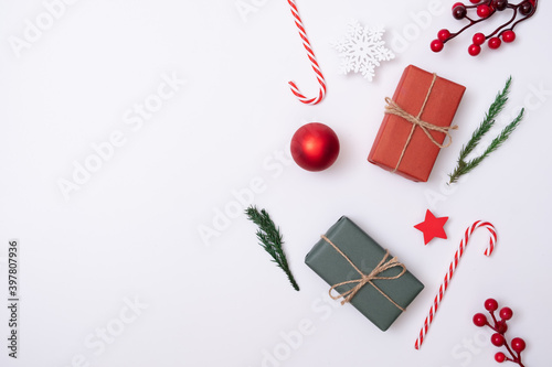 Composition Christmas holiday and happy new year and decoration on white background with gift box and pine branches, flat lay, top view and copy space, for banner card