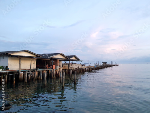traditional fisherman's house on the wooden bridge that located overwater. twilight scenic of Thailand Rayong sea. © WONGSAKORN