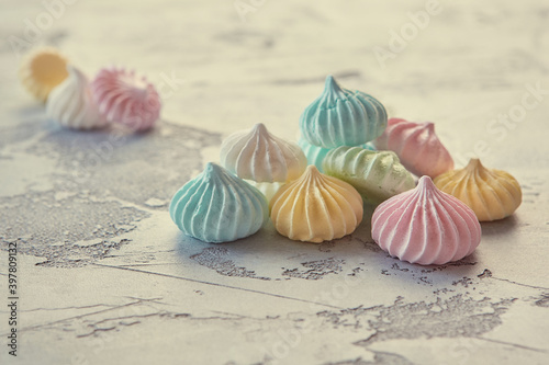 Pastel colored meringue on a beautiful textural background