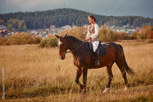 Young woman horseriding in sunset on the fields. Close up © svetlanaz
