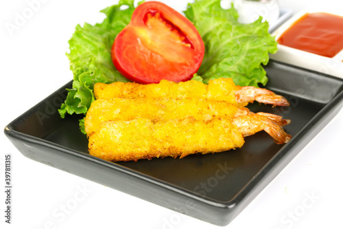 breaded shrimp on black plate isolated on white background