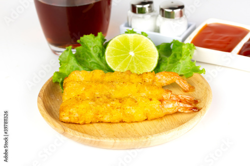 breaded shrimp on wooden plate isolated on white background