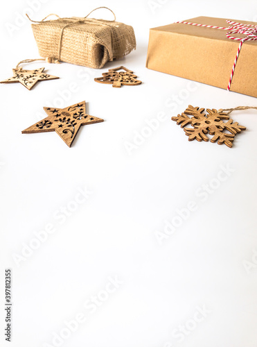 Wooden christmas ornaments with christmas present boxes on an isolated white surface with copy space, front view