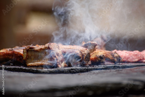 Meat on the grill outdoors. Ribs barbecue on the grill. Selective focus photography.